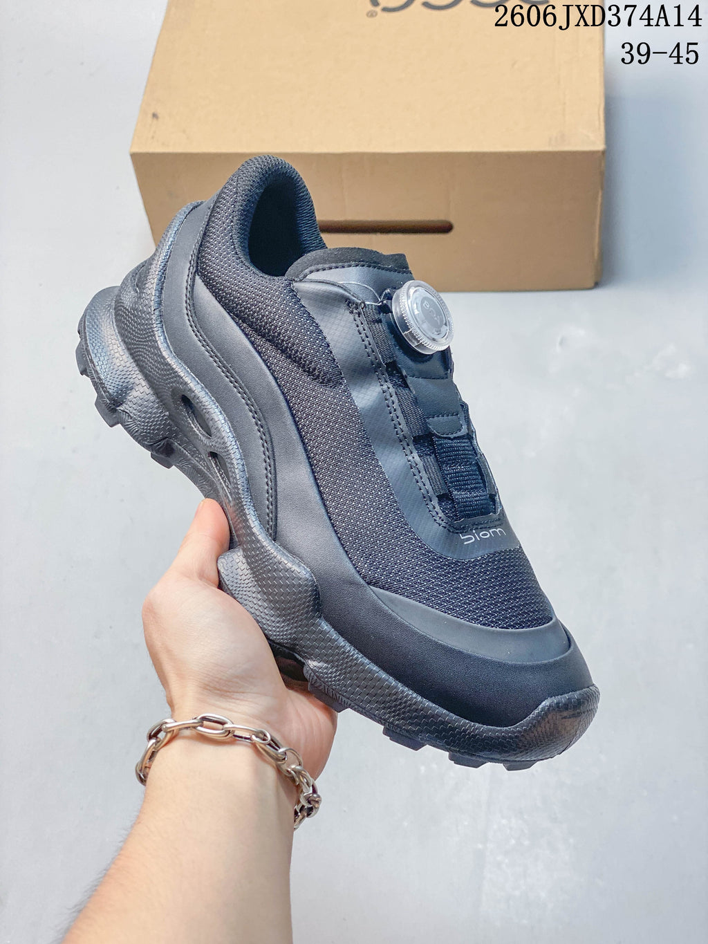 Side view of a gray ECCO BIOM sneaker with dial fastening and textured outsole