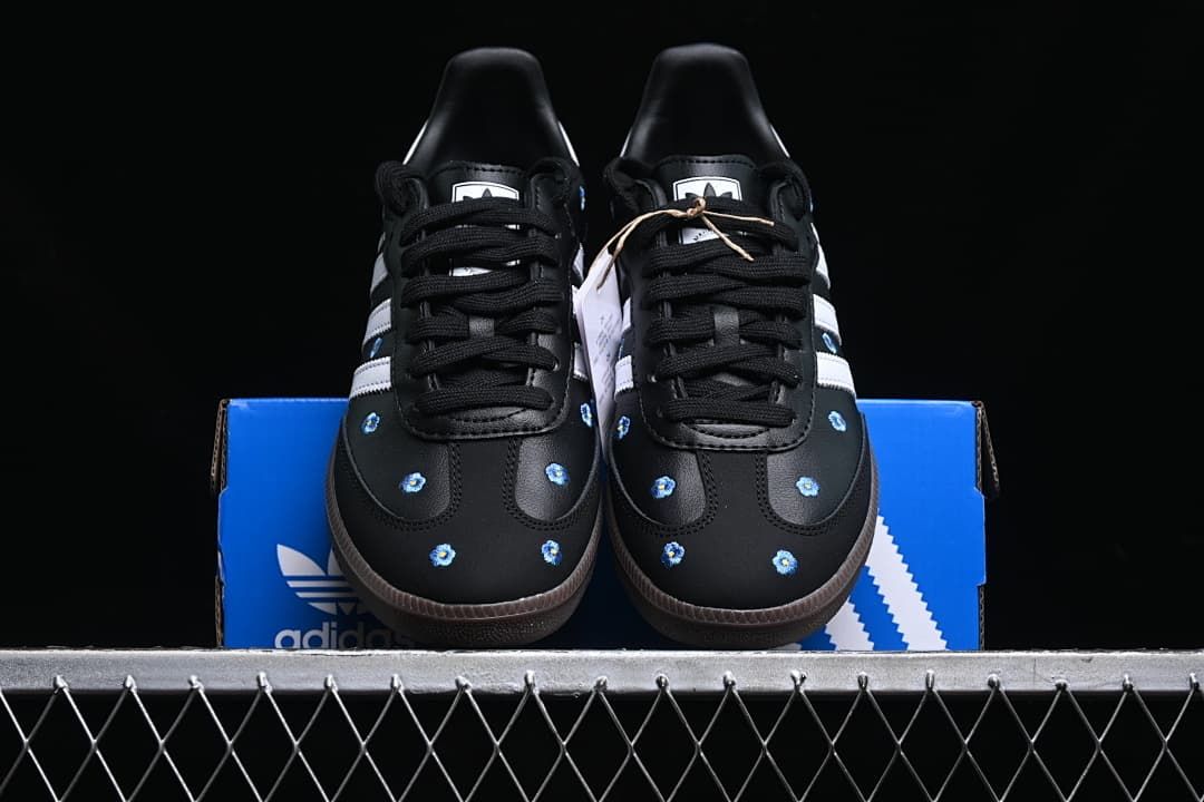 Front view of the pair showing black laces and floral toe details