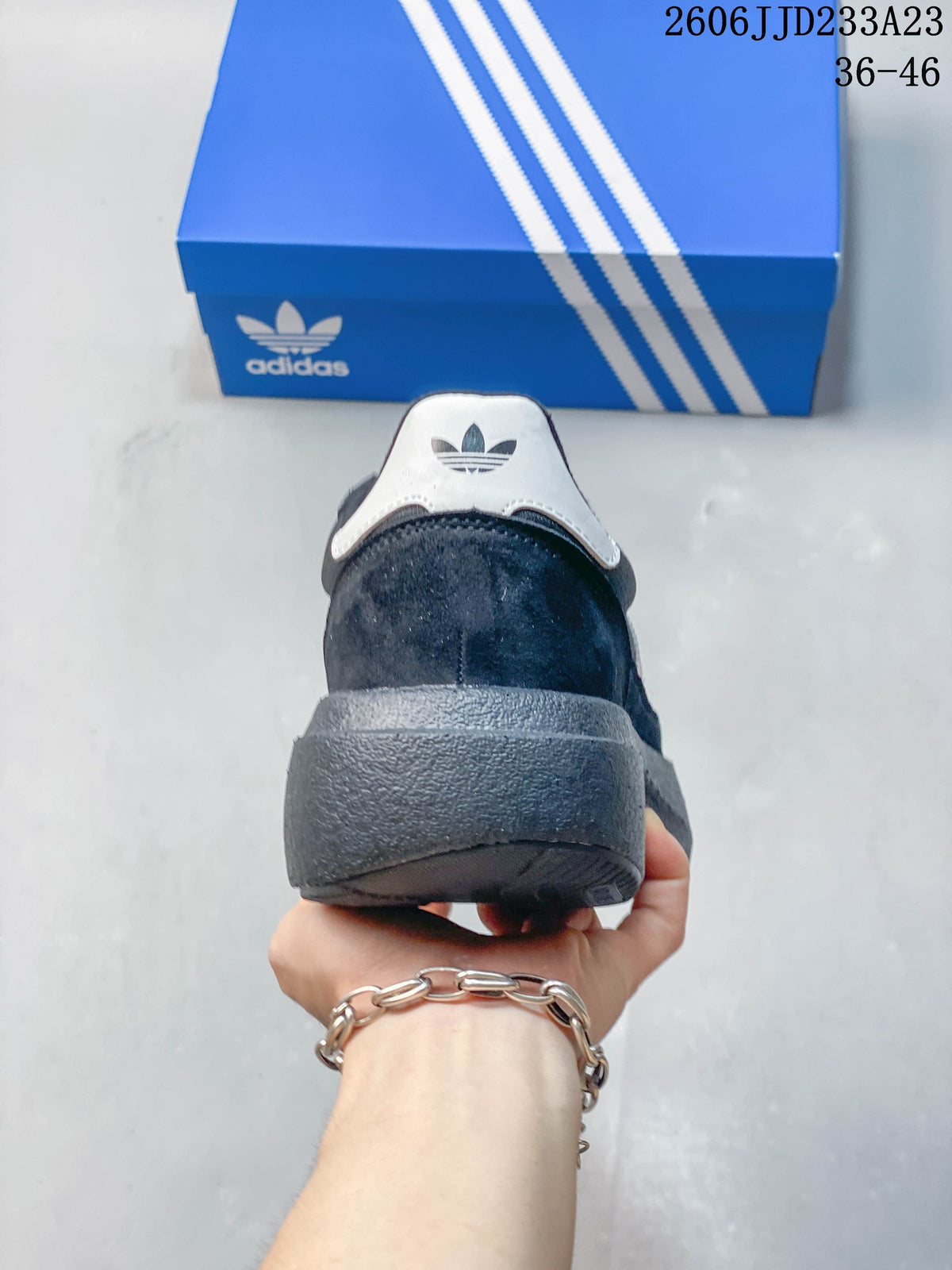 Rear view of a charcoal sneaker showing the white heel detail and chunky sole