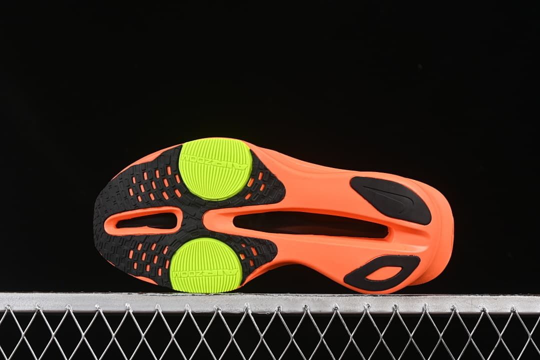 Outsole view with orange, black and bright yellow-green sections