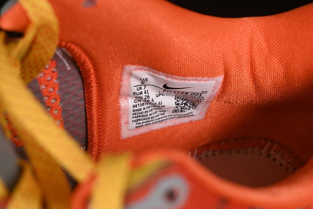 Close-up of the shoe size label inside the orange-lined shoe
