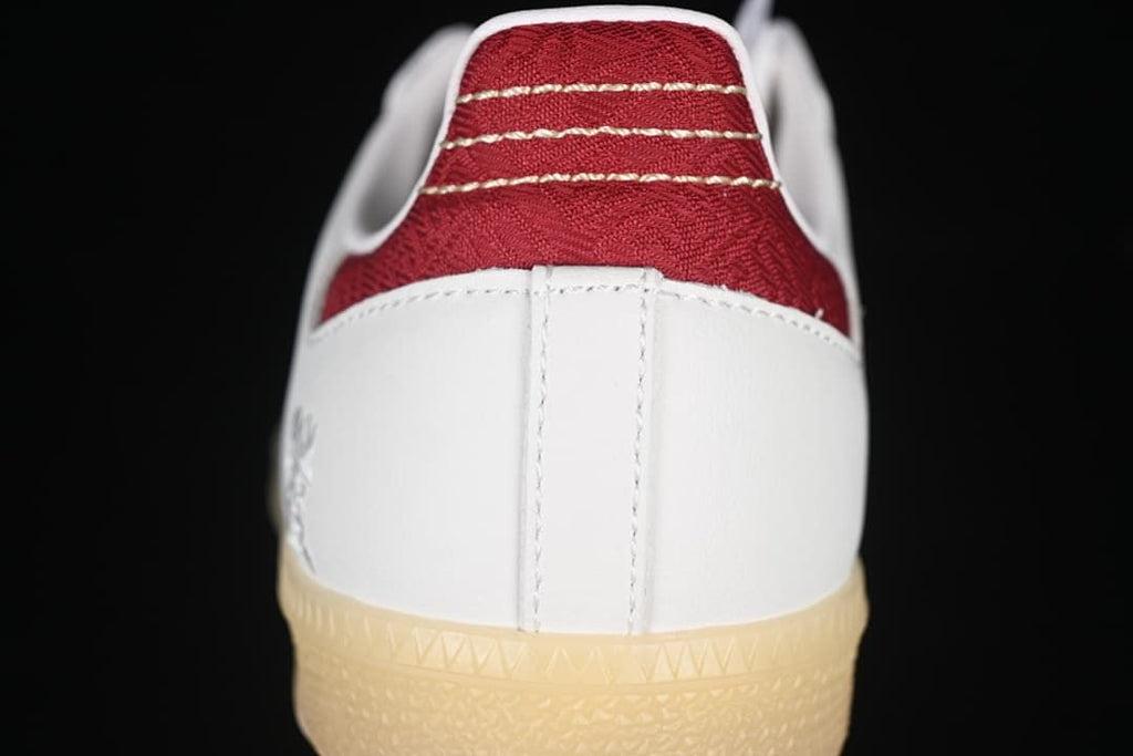Rear view showing red heel detail, white heel panel, and gum outsole