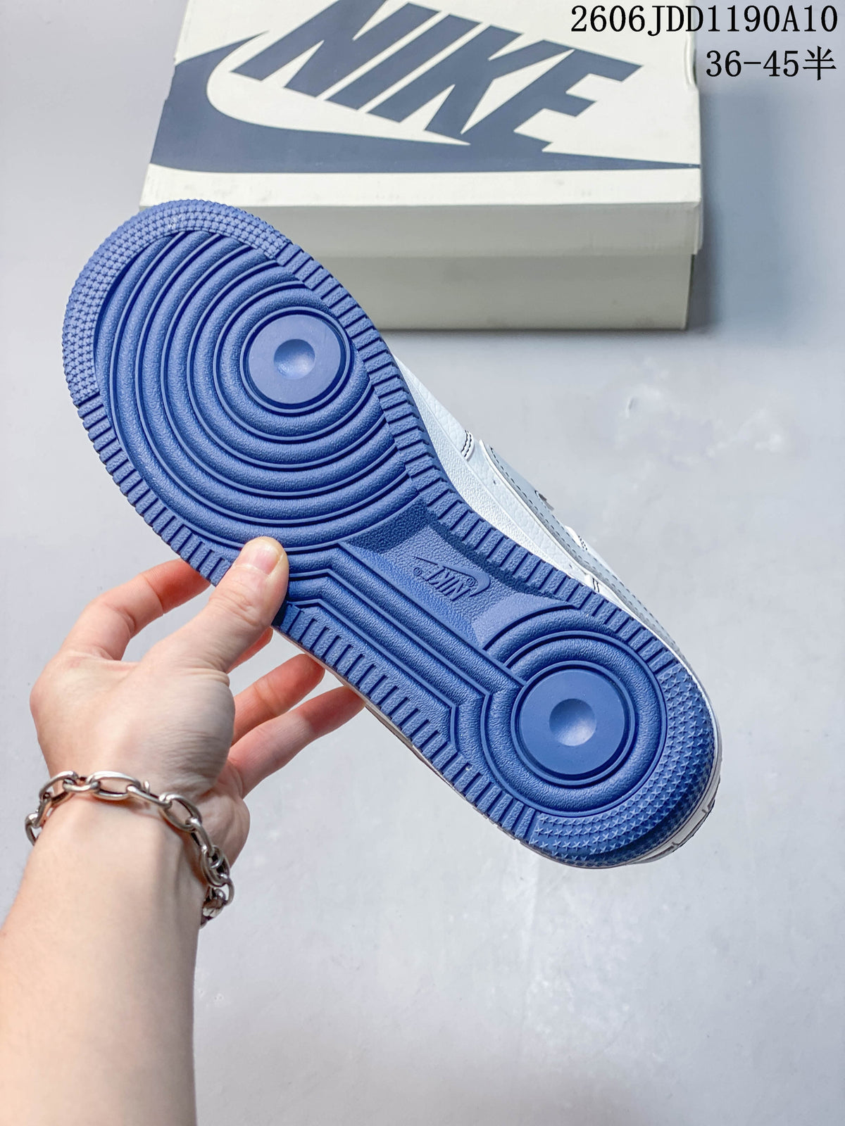 Blue outsole of a white low-top sneaker