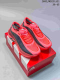 Pair of bright pink Adidas Hyperboost EDGE shoes with dark side panels, displayed on a shoe box.
