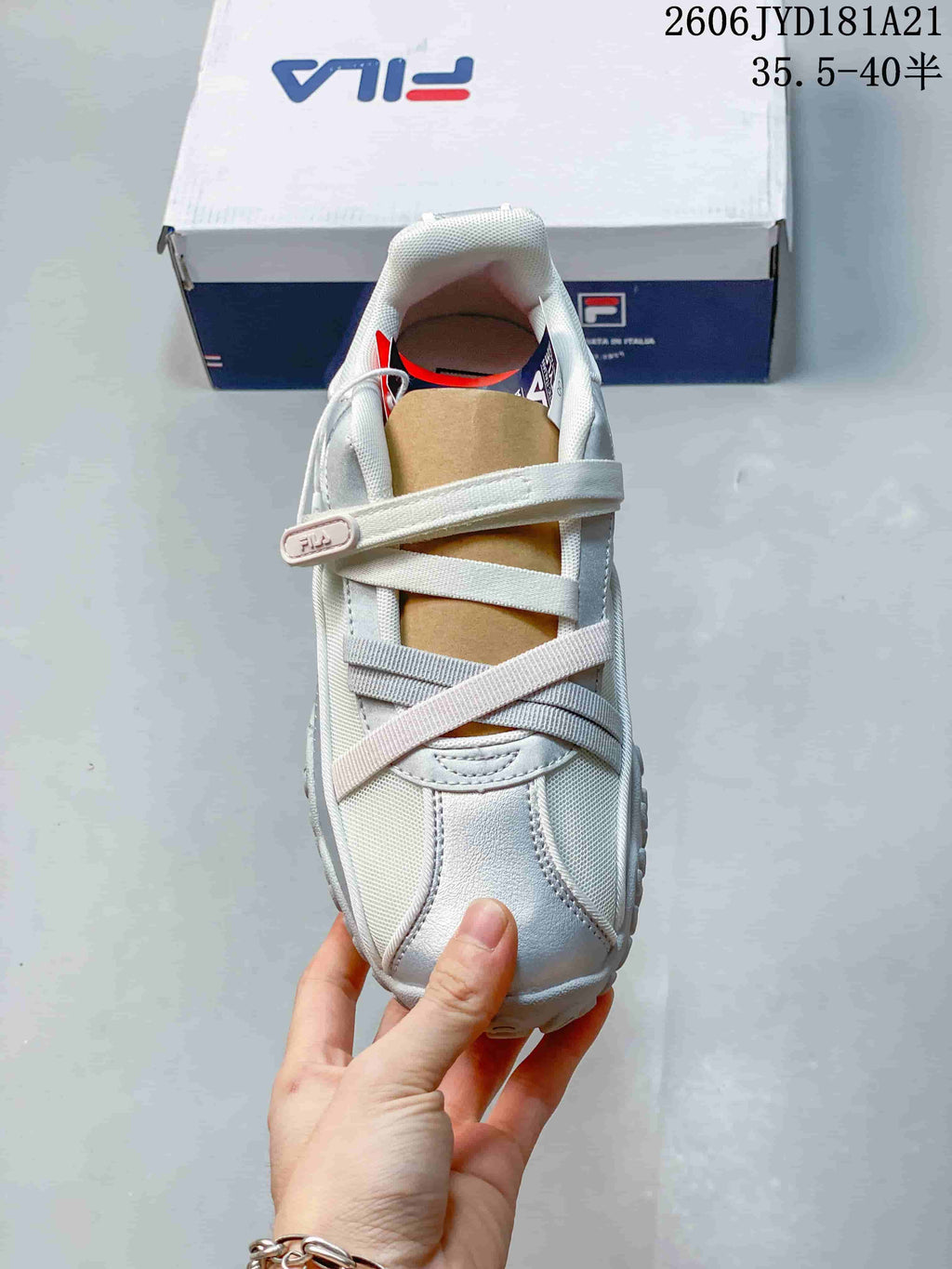 Top view of a FILA shoe showing its crossed straps and silver toe detailing