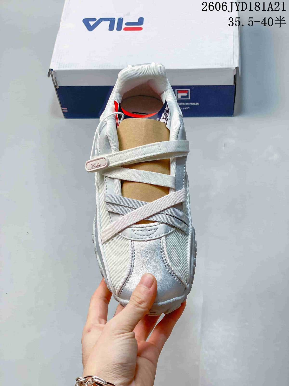 Top view of a FILA shoe showing its crossed straps and silver toe detailing