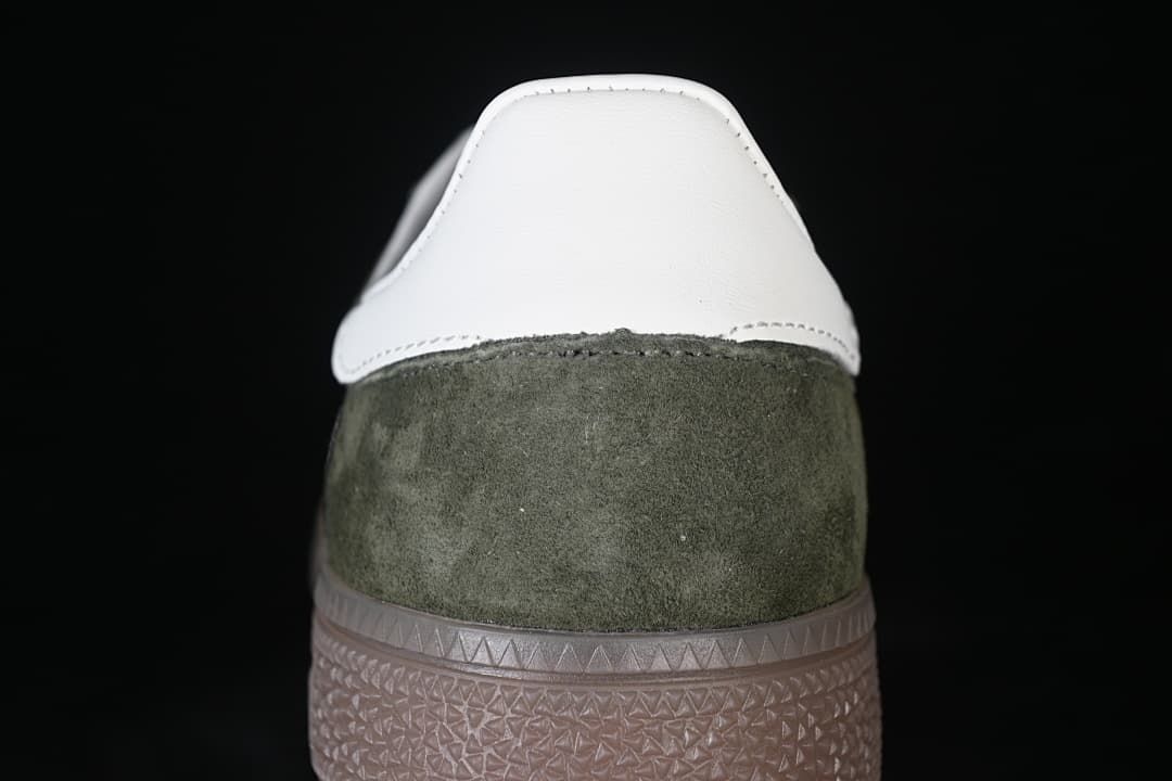 Rear view showing the white heel panel, green upper, and gum-colored sole