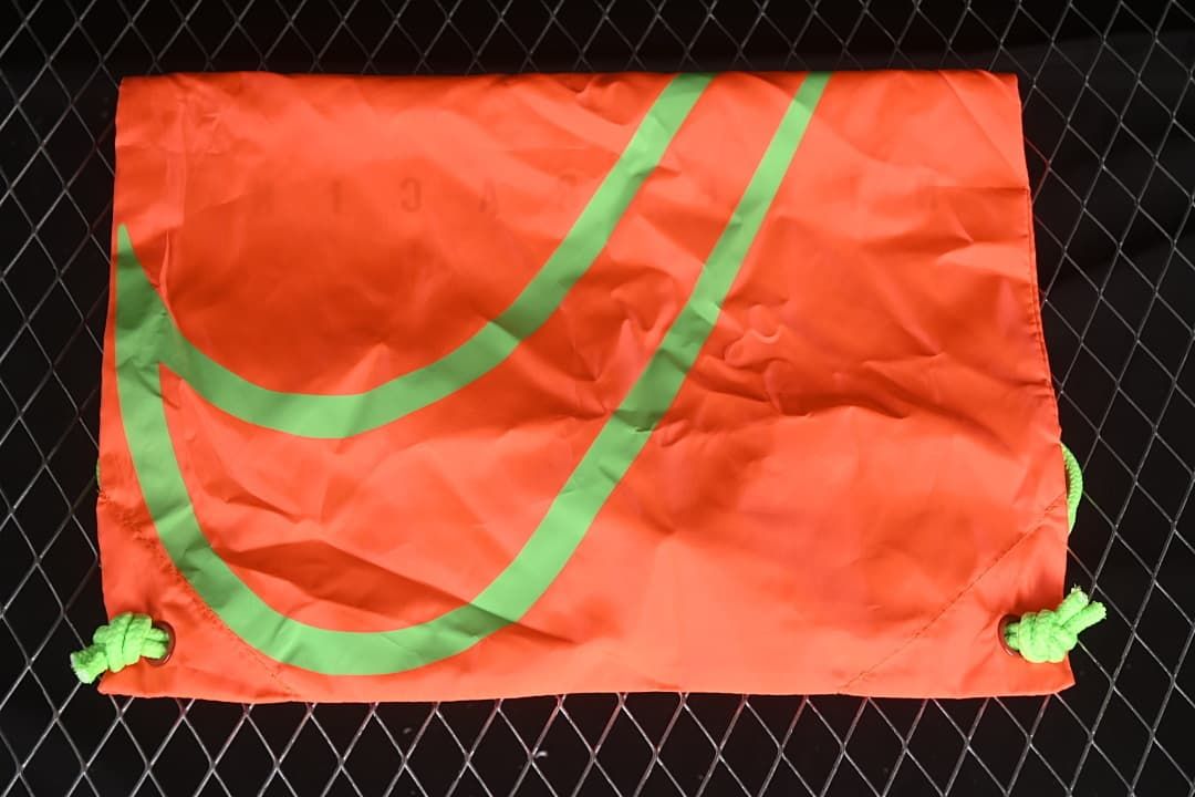 Bright-crimson drawstring shoe bag with a large lime graphic.