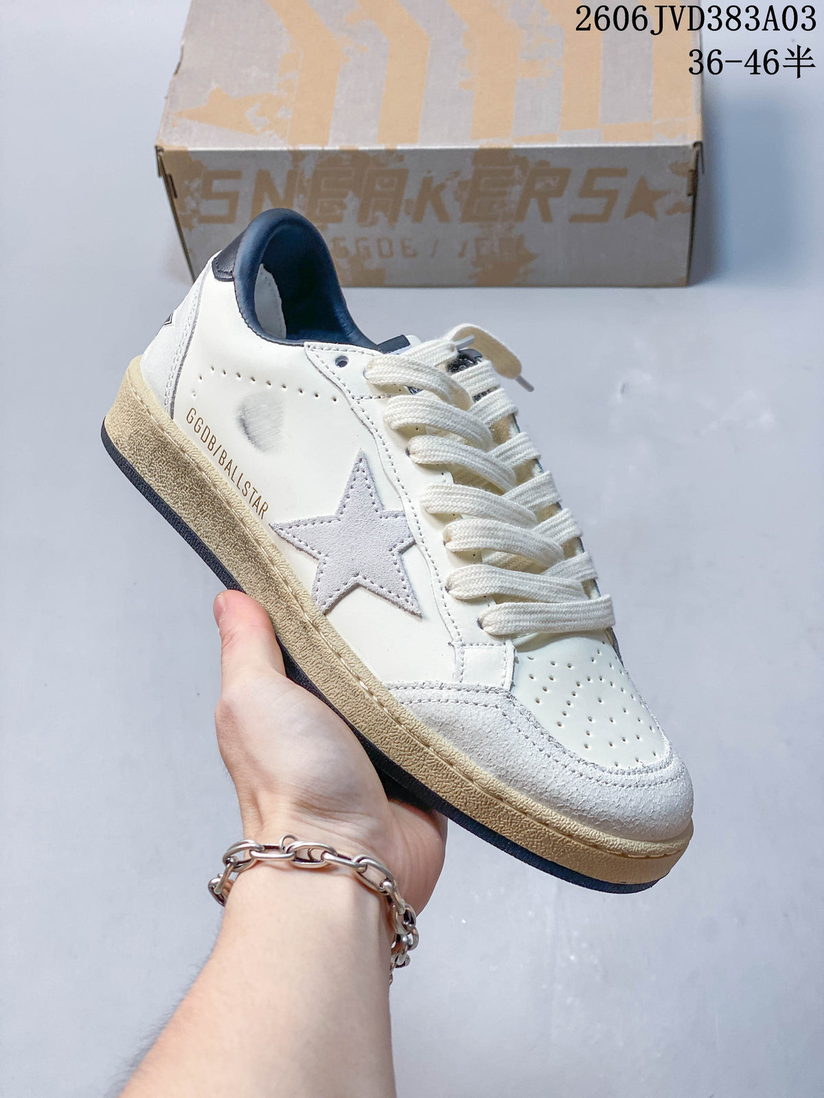 Side view of Golden Goose low-top sneaker with star detail, navy accents, and distressed-looking finish