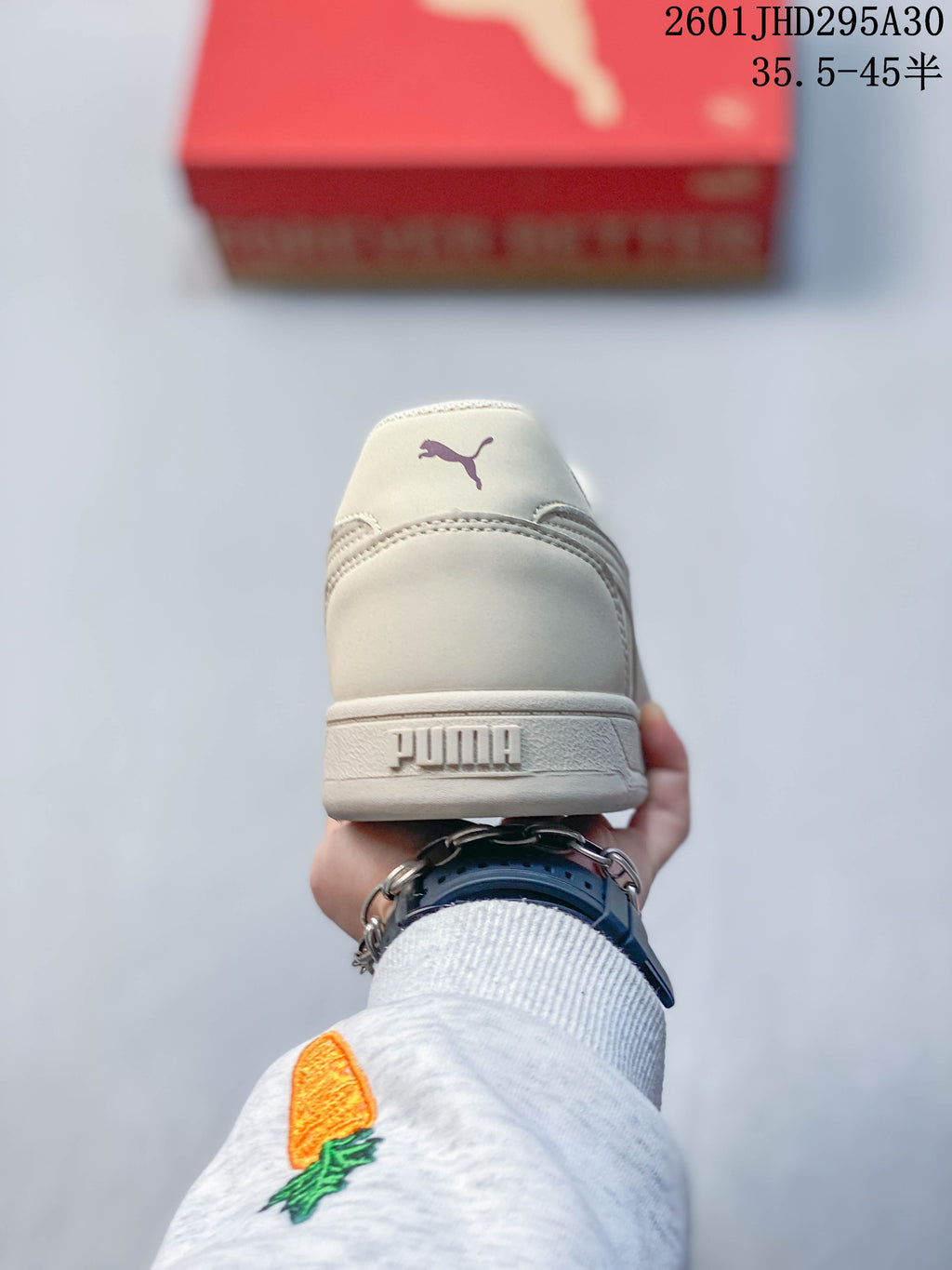 Rear view of a cream Puma sneaker showing the heel branding