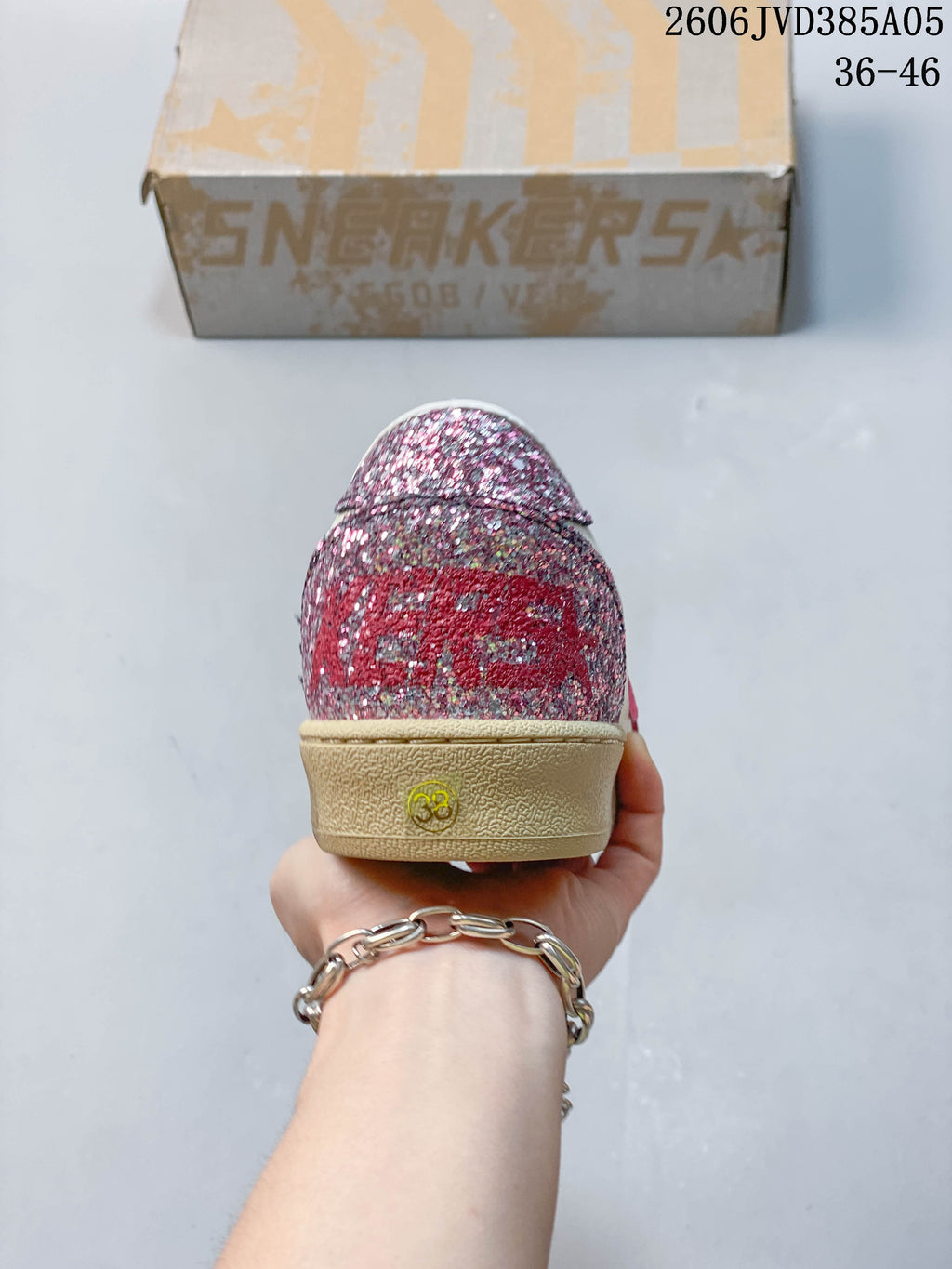 Rear view showing the glittery pink heel panel and beige-toned sole.