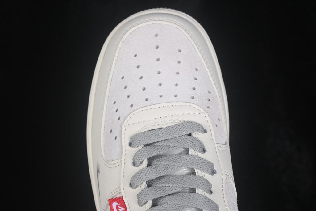 Close-up of the white and gray perforated toe box with gray laces.