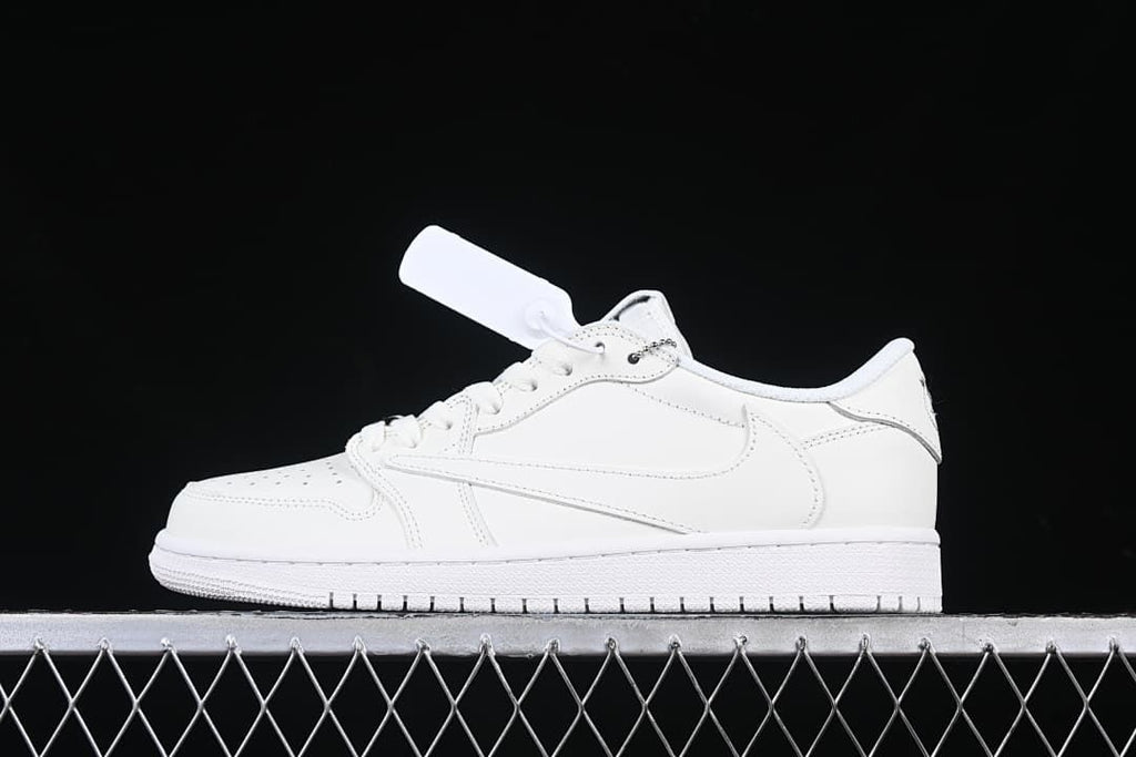 Side view of a white low-top sneaker with a lace charm against a dark background.