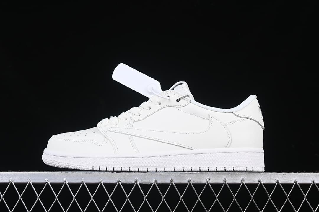Side view of a white low-top sneaker with a lace charm against a dark background.