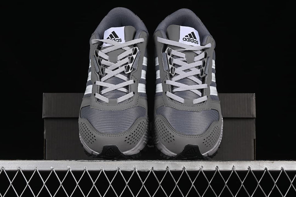 Front view of the pair with mesh toe panels and lace-up closures