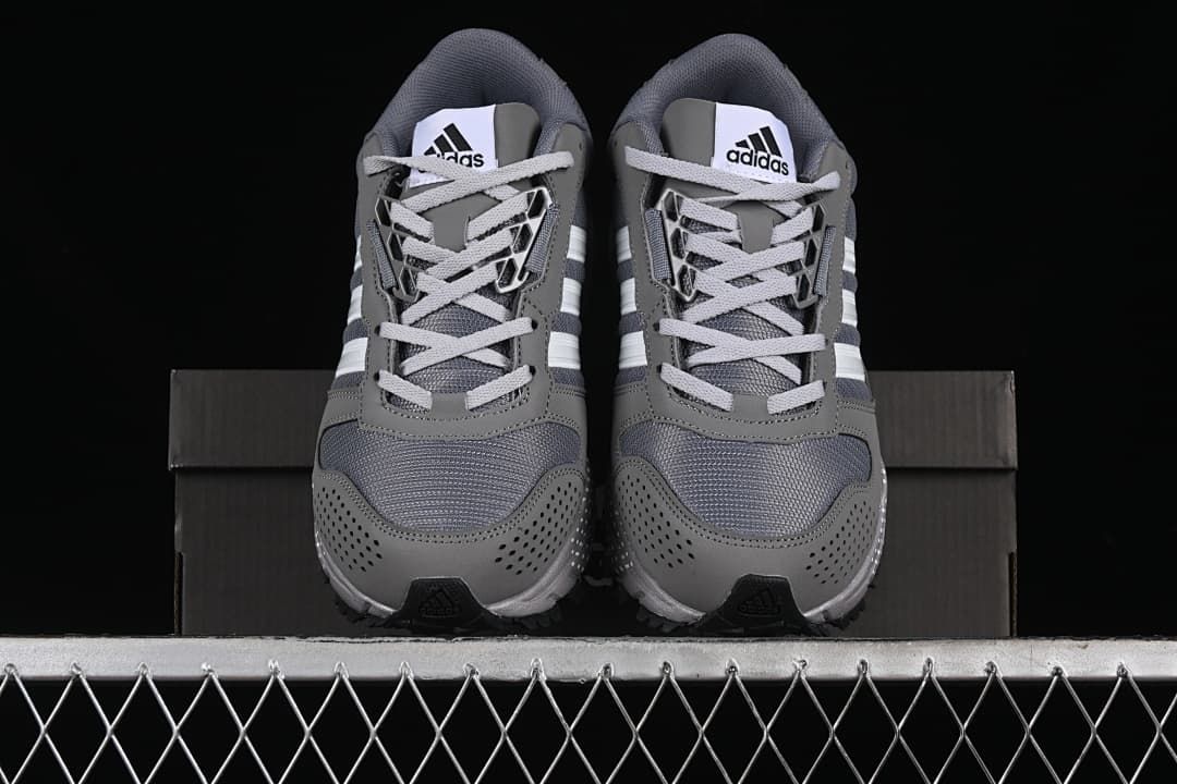 Front view of the pair with mesh toe panels and lace-up closures