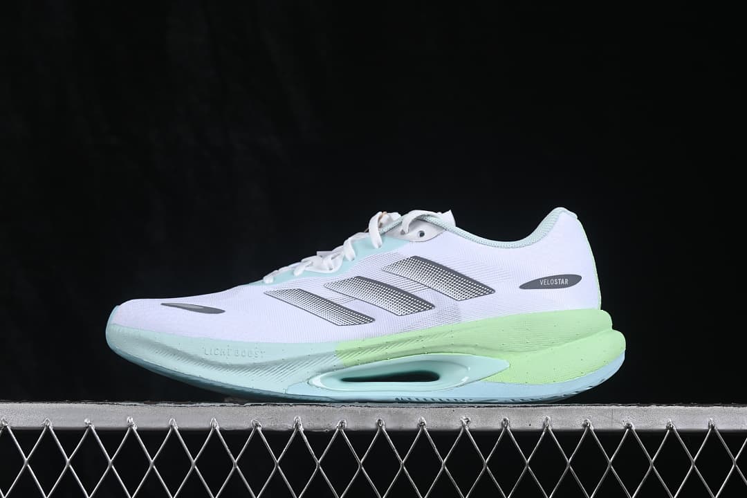 Side profile of the sneaker showing the mint forefoot and lime heel accents