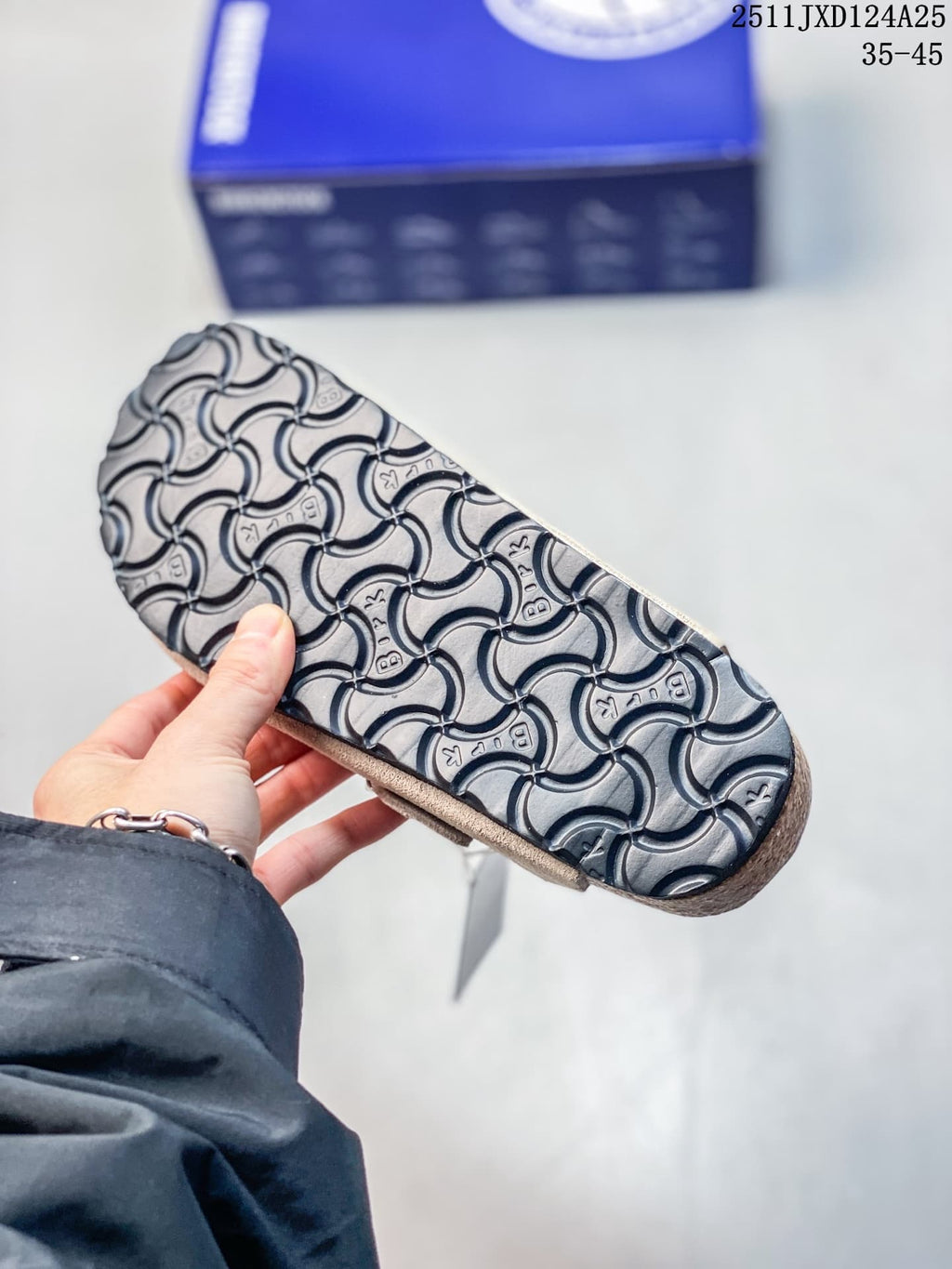 Close-up of the black patterned outsole on a taupe clog