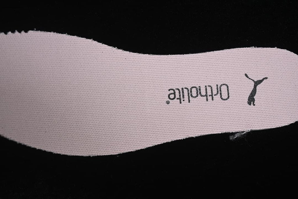 Close-up of a pale pink insole with Puma branding.