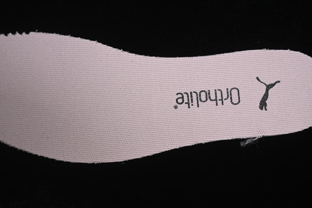 Close-up of a pale pink insole with Puma branding.