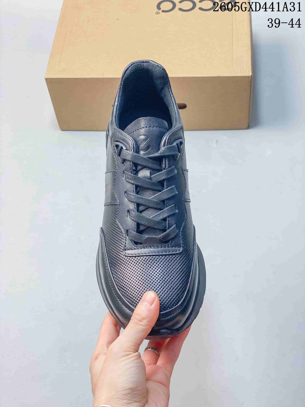 Top view of the sneaker showing its laces and perforated toe panel