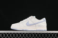 Side profile of a white Nike SB Dunk Low with a light blue Swoosh