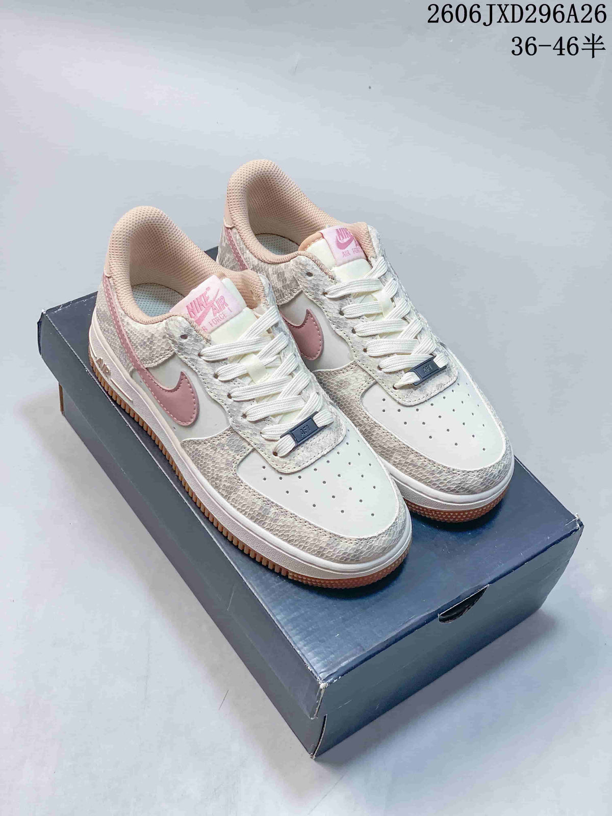 Cream Nike Air Force 1 low-top sneakers with pink Swooshes and textured patterned overlays