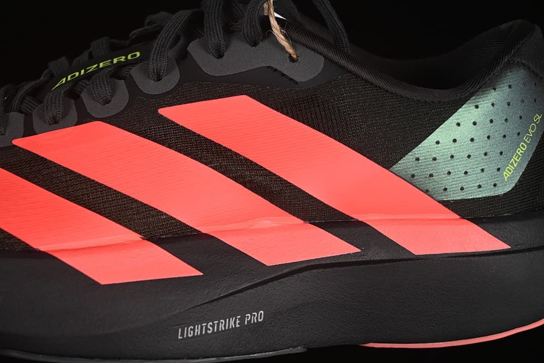 Close-up of the shoe side with coral stripes and Lightstrike Pro text