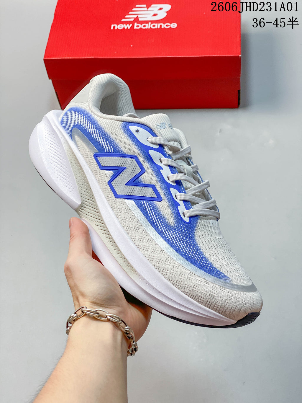 Angled side view showing the shoe's white and blue upper and sculpted sole