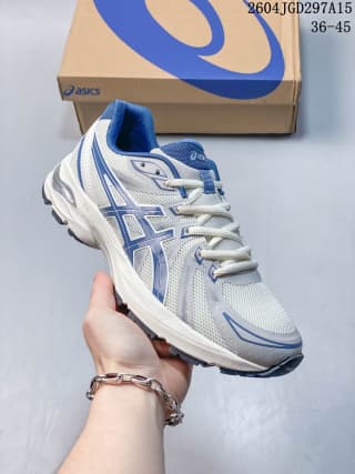 White and blue ASICS Gel-Flux CN sneaker held in front of an ASICS shoe box; box text shows 36–45 and 2604JGD297A15.