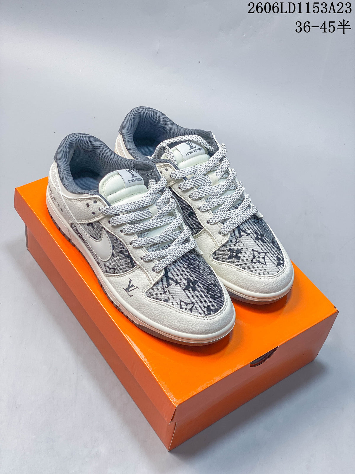 Off-white and gray low-top sneakers with patterned panels, pictured on an orange box