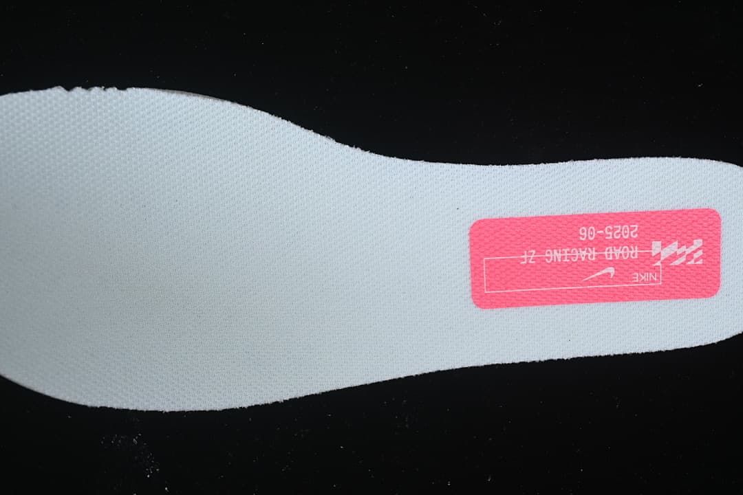 Close-up of a light blue shoe insert with a pink Nike label.