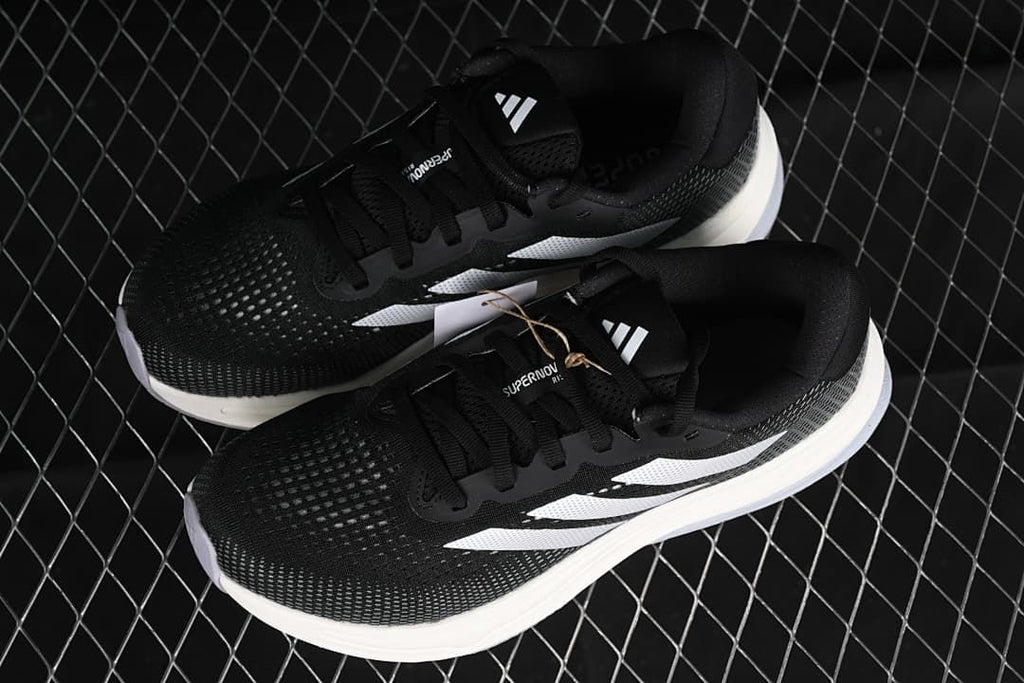 Pair of black and white adidas Supernova Rise W shoes shown from above.