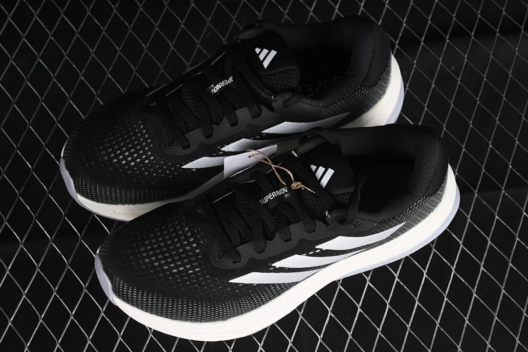 Pair of black and white adidas Supernova Rise W shoes shown from above.