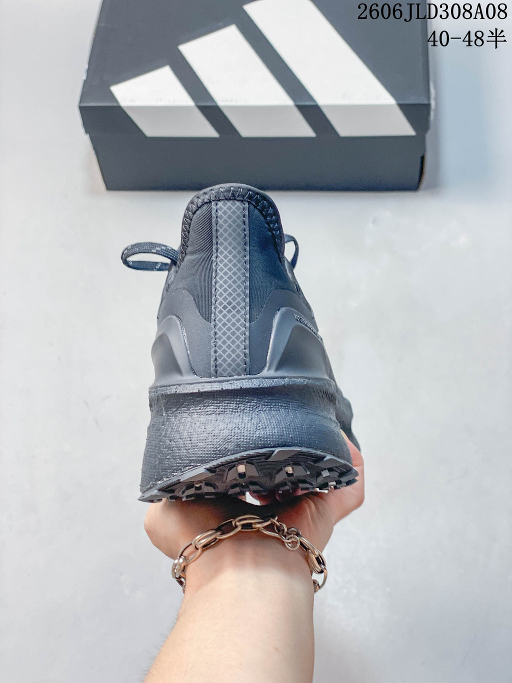 Rear view showing the heel and outsole of the dark gray shoe.