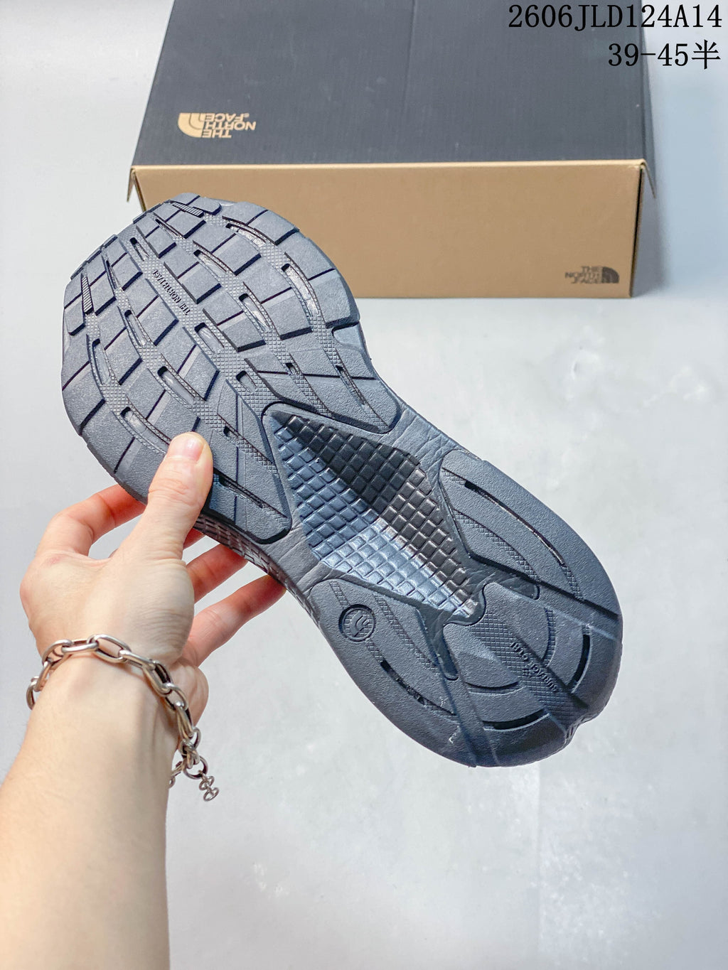 Close-up of the gray shoe outsole showing its patterned tread.