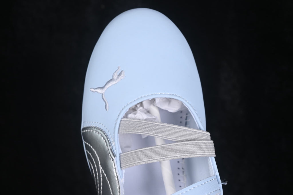 Close-up of the toe area with embroidered Puma branding and layered straps.