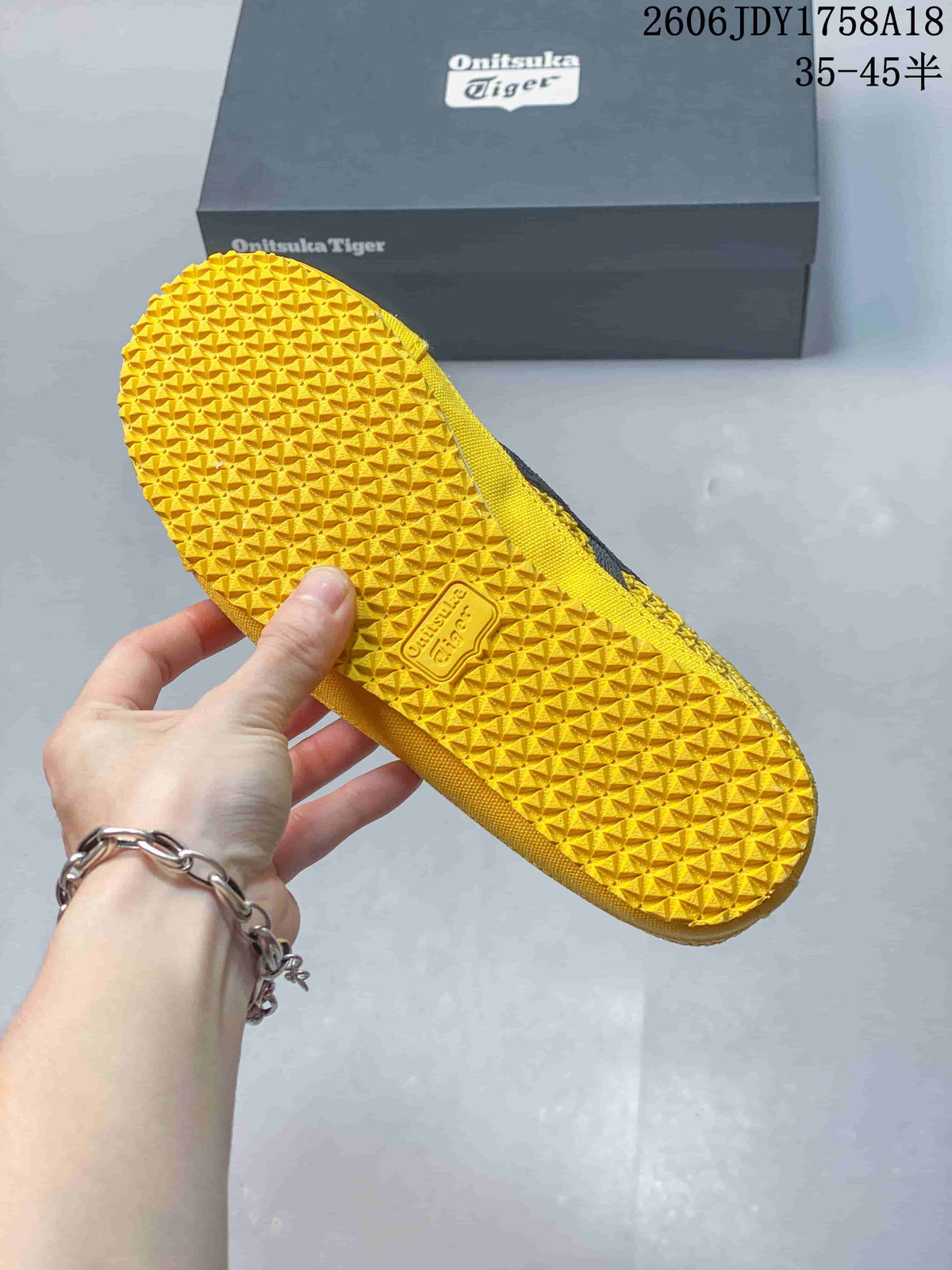 Close-up of the textured yellow outsole on an Onitsuka Tiger Mexico 66 Sabot sneaker