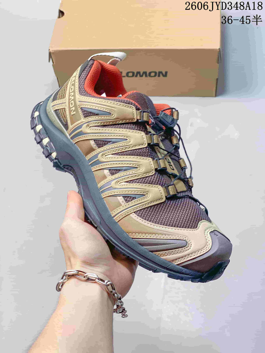 Close-up side view of a tan and brown Salomon XT-3D shoe.