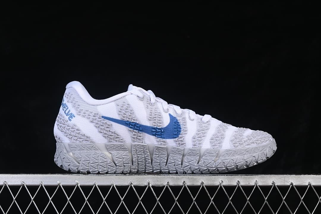 Side view of the shoe with a blue Swoosh and grey patterned sole