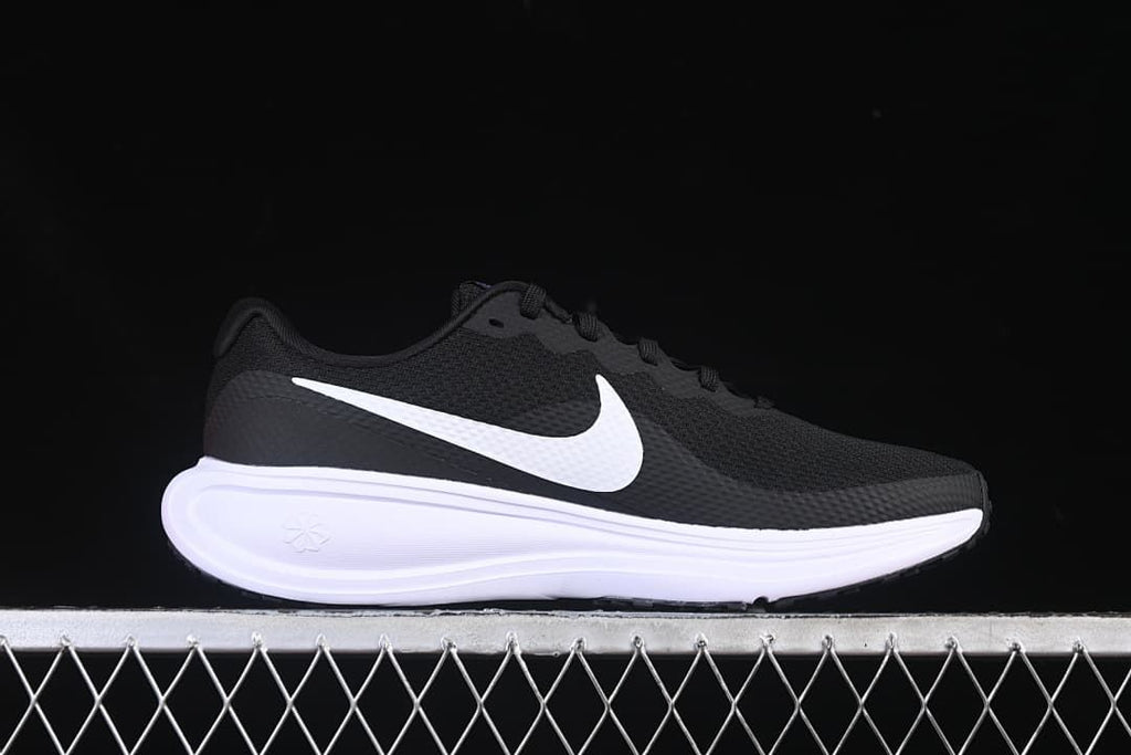 Side profile of a black Nike Revolution 8 shoe with white Swoosh and midsole