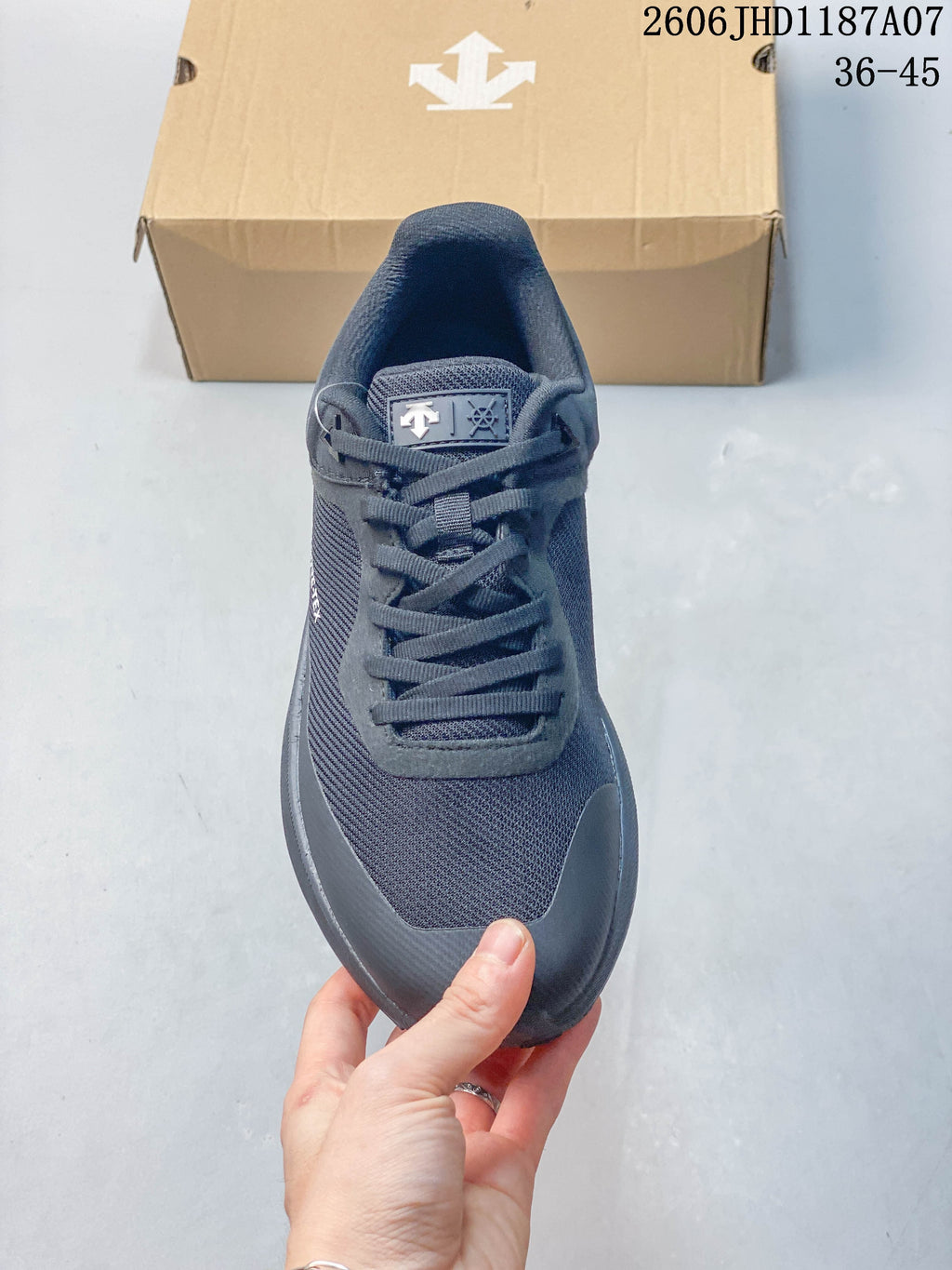 Top view of the laces and mesh-look panels on a Descente sneaker
