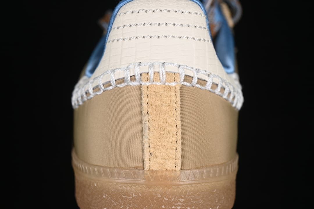 Rear view of the sneaker showing cream heel detail and stitched overlays