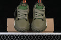 Front view of olive Air Jordan 1 Low Element sneakers with gray laces, green tongues, and orange pull tabs.