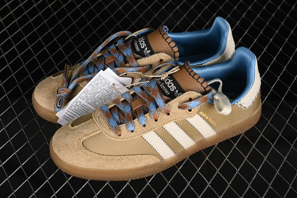 Pair of tan Wales Bonner Samba sneakers with cream stripes and blue accents