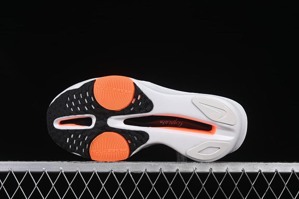 Underside view showing black and orange outsole sections.