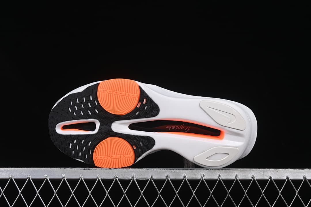 Underside view showing black and orange outsole sections.