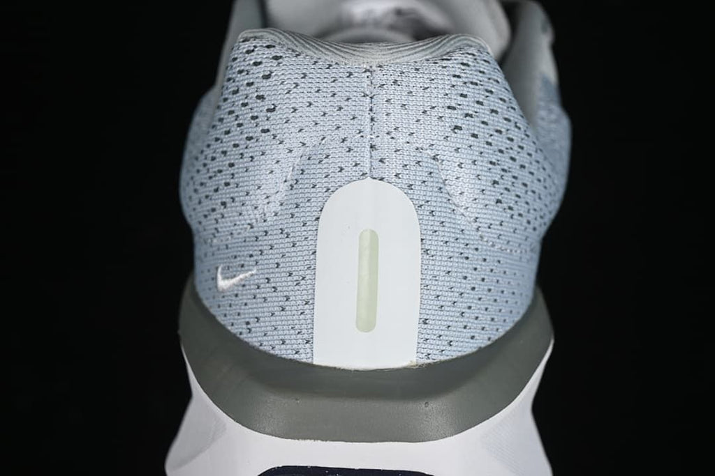 Close-up of the shoe heel with gray patterned upper and white heel detail