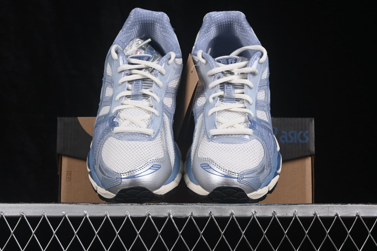 Front view of the pair showing the cream mesh toe boxes, white laces, blue overlays, and ASICS branding.