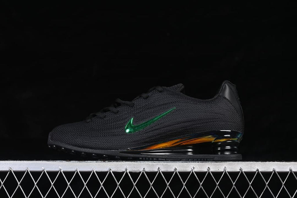 Side view of the black sneaker with green Swoosh and iridescent heel accent.